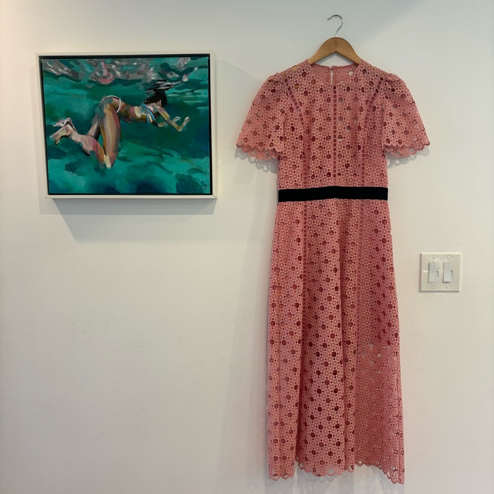 Pink lace short-sleeve Sandro dress with black cotton belt detail at waist.